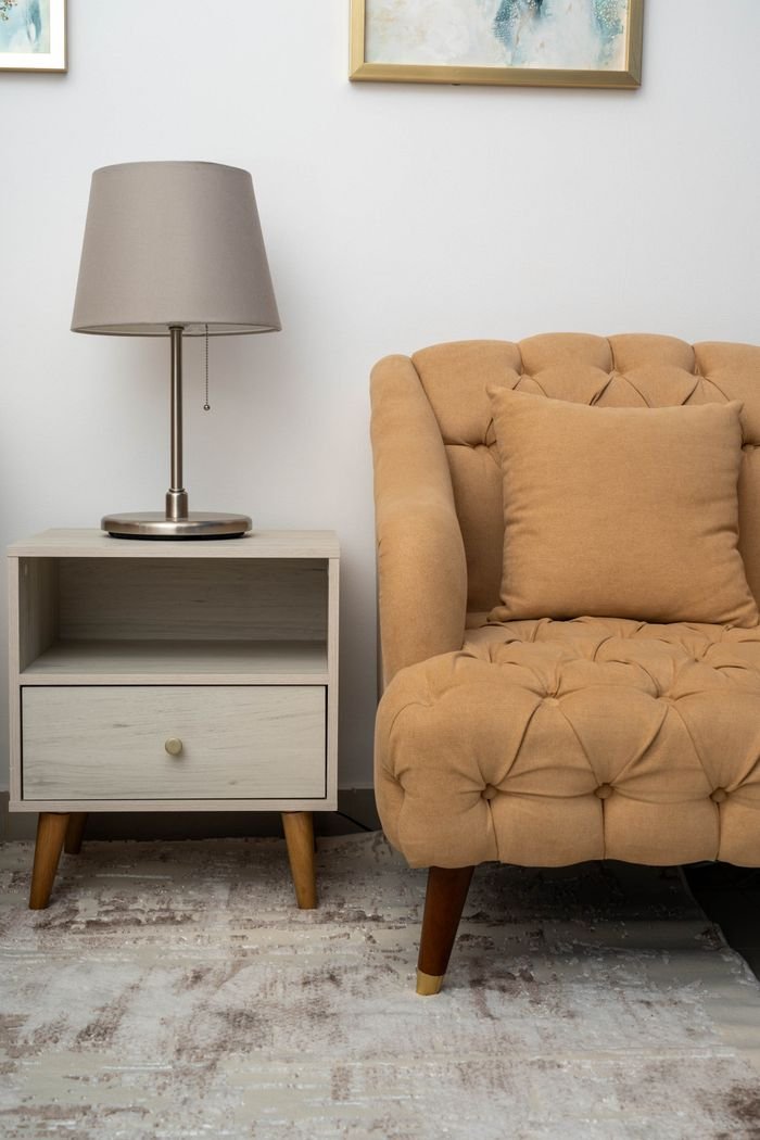 Stylish living room interior with sofa, lamp, and side table for a cozy home ambiance.